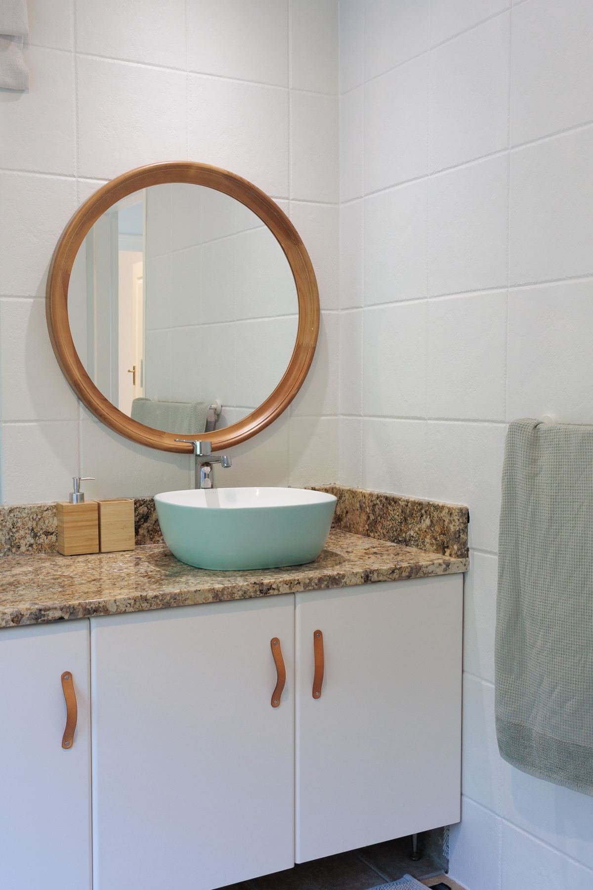 Guest bathroom vanity with a round mirror