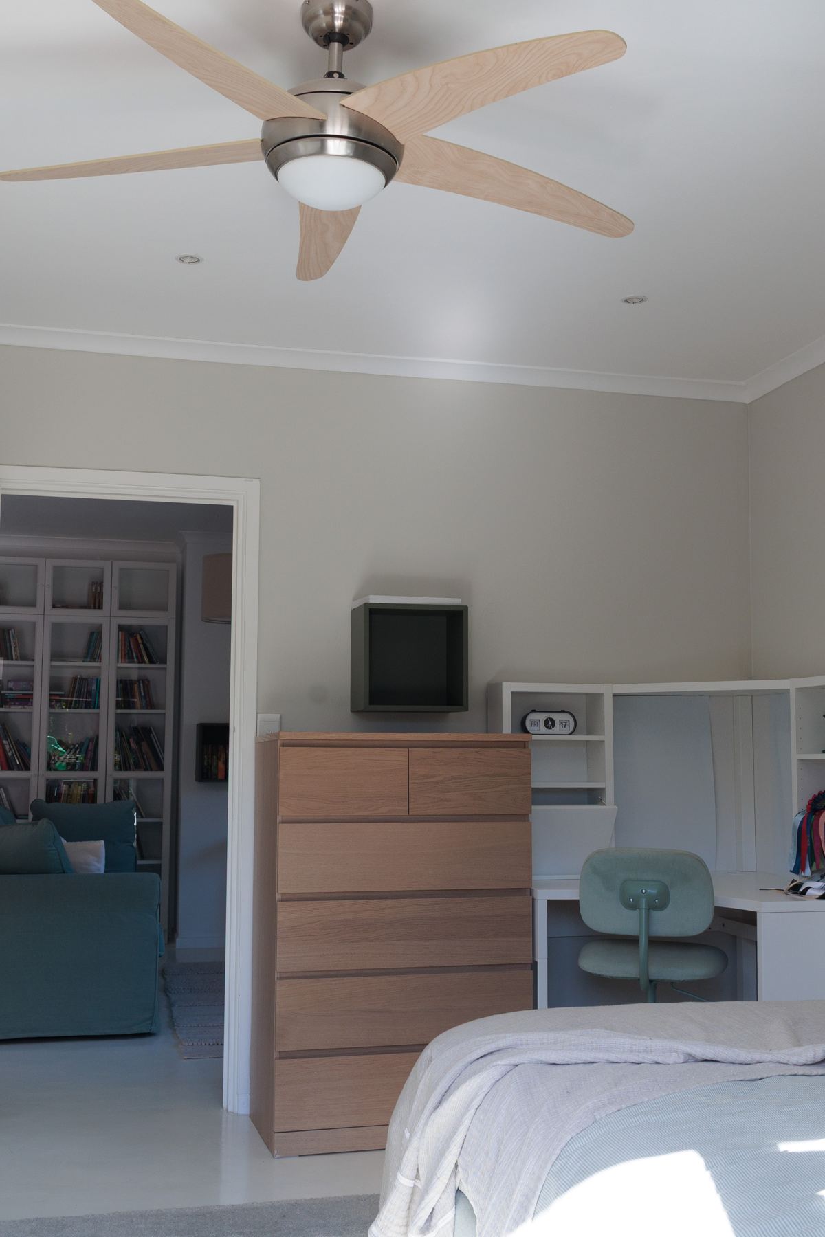 Upstairs bedroom with a ceiling fan and chest of drawers