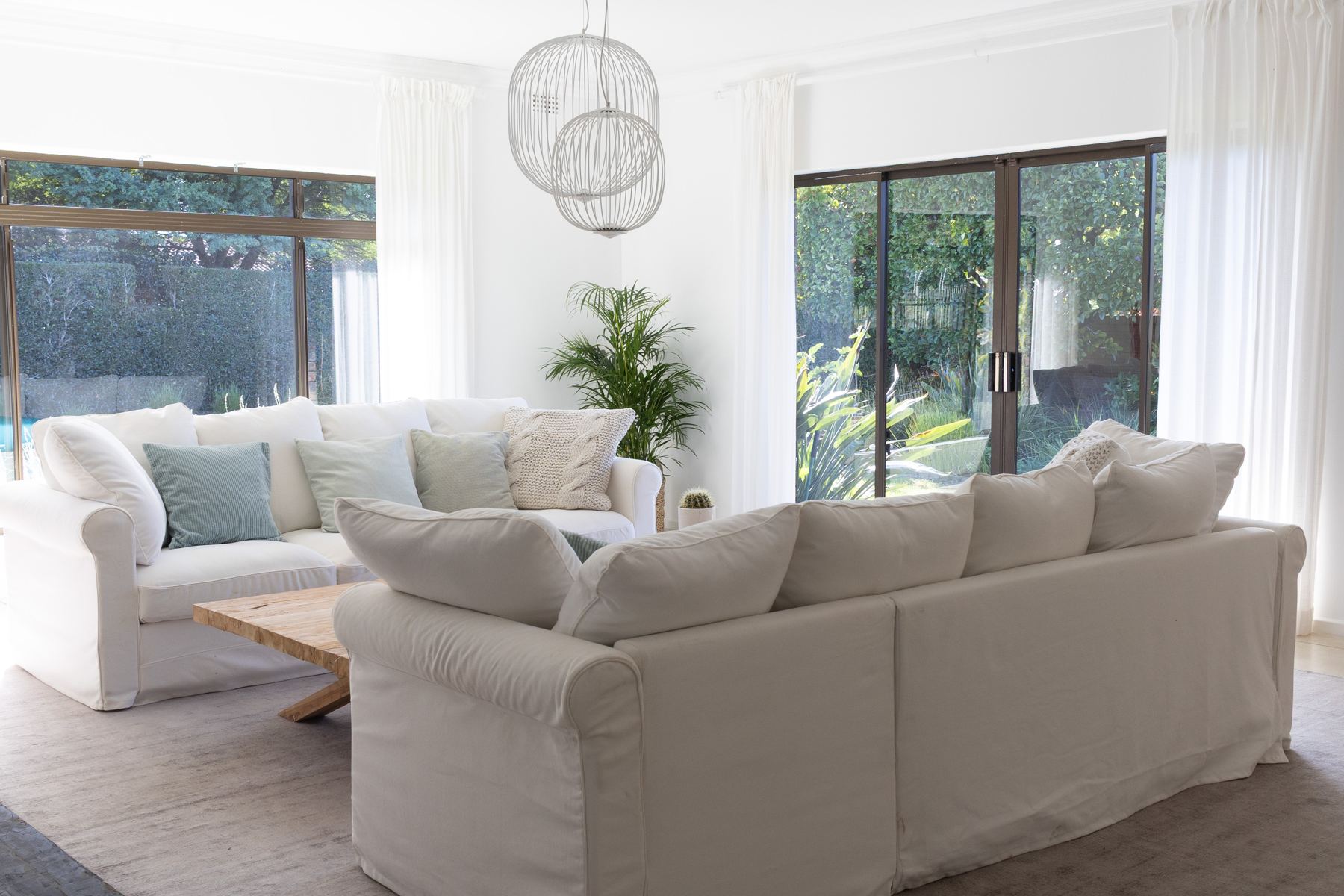 Lounge with white sofas and a timber coffee table