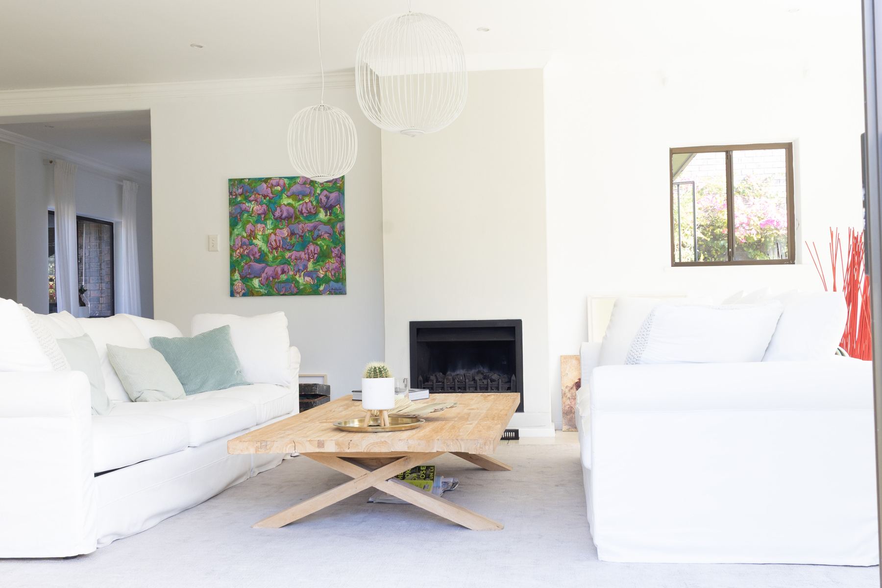 Open lounge with a fireplace and timber coffee table