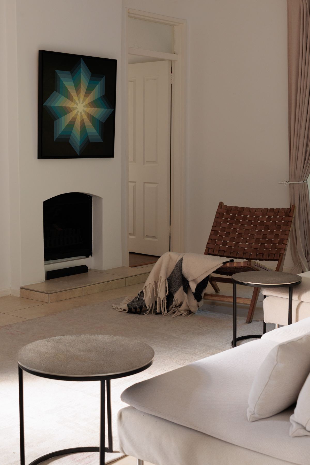 TV room with a fireplace and wicker chair