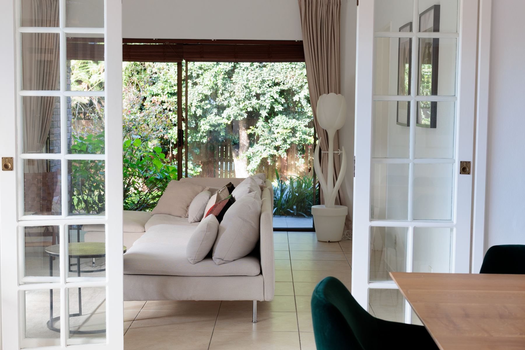 TV room with glass doors opening to the garden