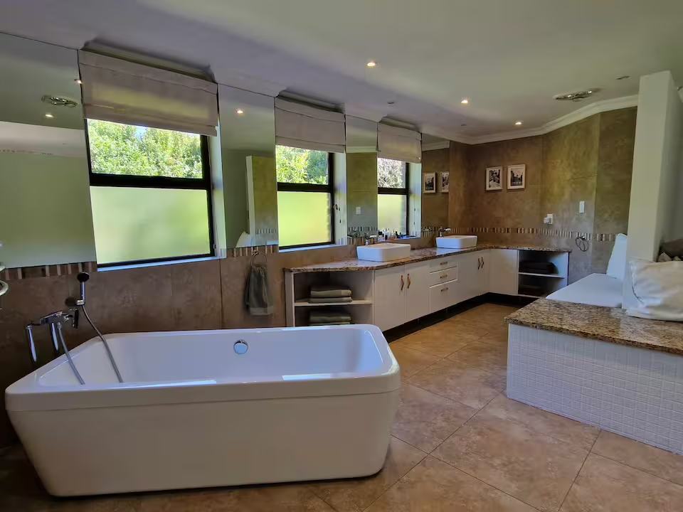 Spacious bathroom with double vanity and tub