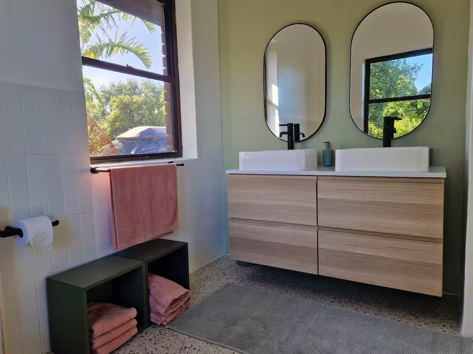 Modern bathroom with twin mirrors and natural light