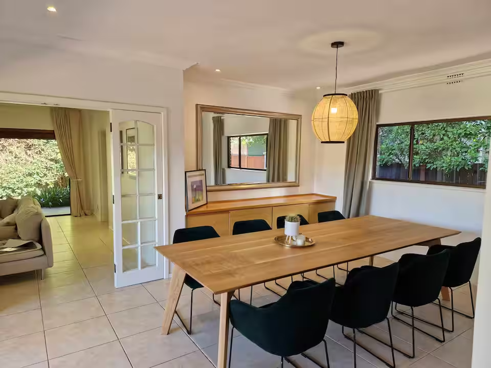 Dining area with pendant lighting and garden views
